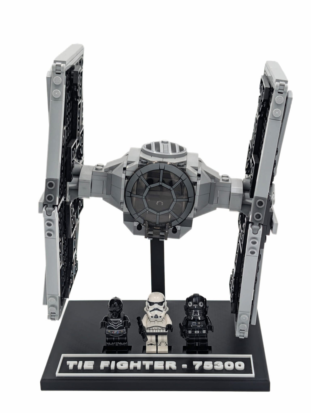 LEGO® Tie Fighter 75300 mounted on a black display stand, front view