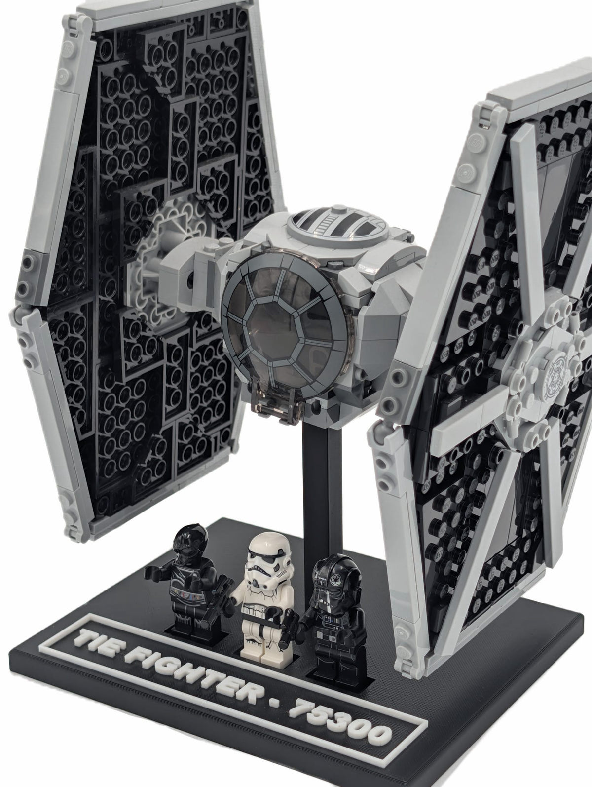 LEGO® Tie Fighter 75300 mounted on a black display stand, front three-quarter view