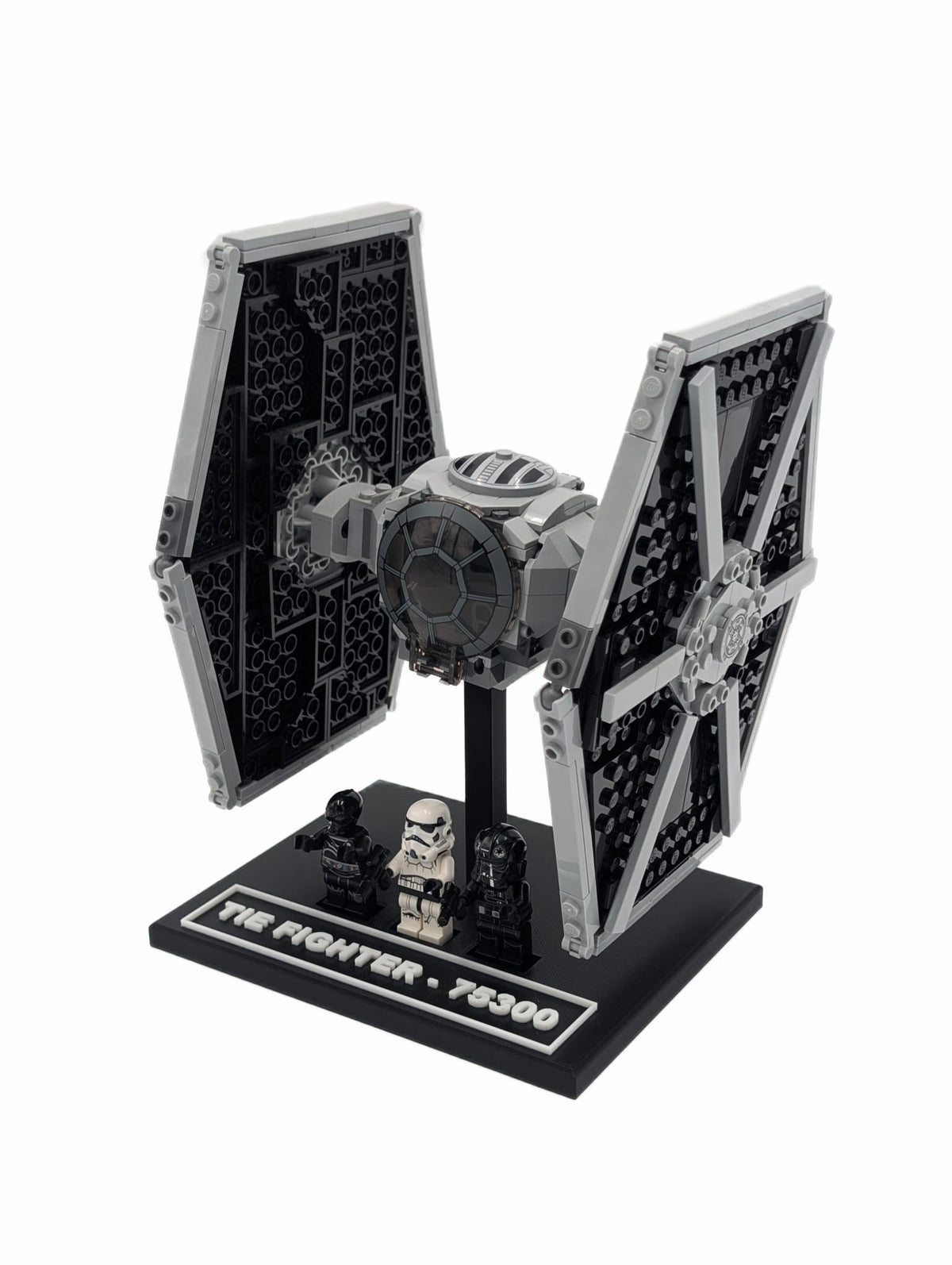 LEGO® Tie Fighter 75300 mounted on a black display stand, angled front view