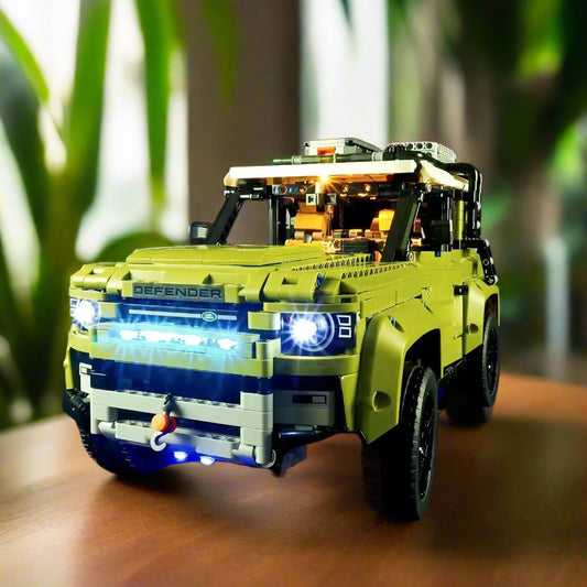 Cinematic front view of LEGO® Land Rover Defender (42110) with LED light kit – dramatic lighting highlighting rugged design and illuminated headlights